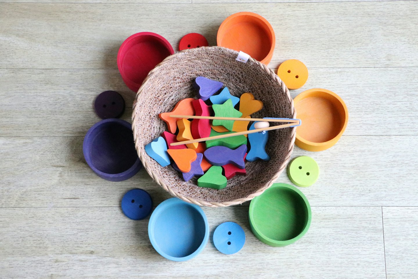Colorful wooden educational toys spilling from a woven basket.